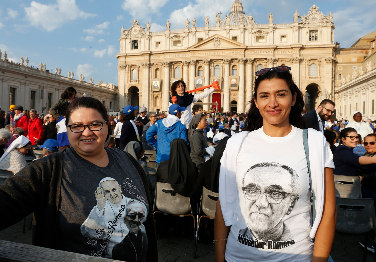 Women wait for the start of the canonization Mass for seven new saints celebrated by Pope Francis in St. Peter’s Square at the Vatican Oct. 14. Among those canonized were St. Paul VI and St. Oscar Romero.